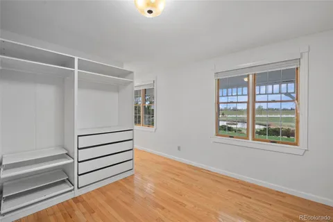 a view of a room with wooden floor and white walls