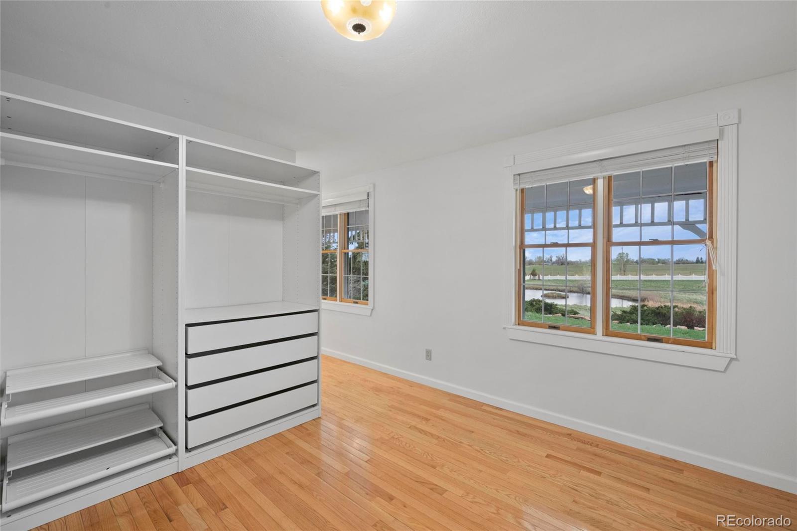 6231 Prospect Road Longmont, CO 80503 - Photo 22 of 45 a view of a room with wooden floor and white walls