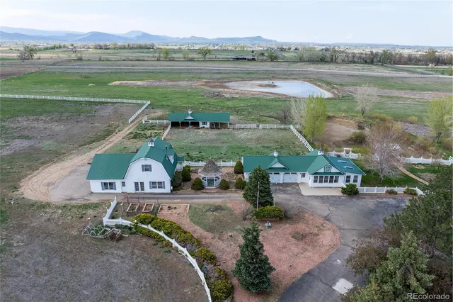 an aerial view of a house with outdoor space and lake view