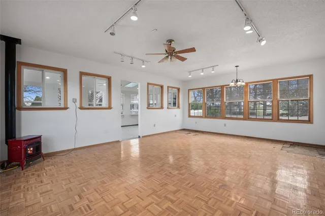 a view of an empty room with a window and fireplace