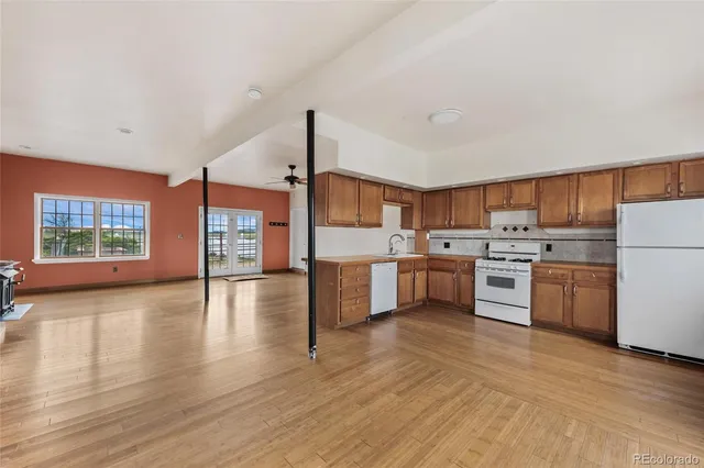 a kitchen with a sink cabinets and wooden floor