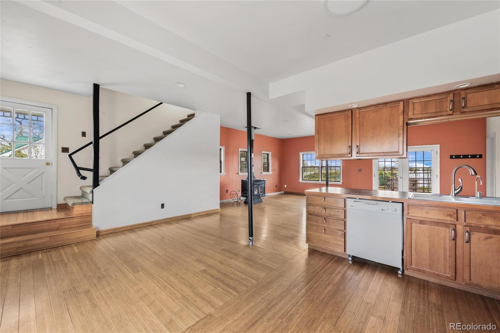 6231 Prospect Road Longmont, CO 80503 - Photo 37 of 45 a kitchen that has a lot of cabinets and wooden floor