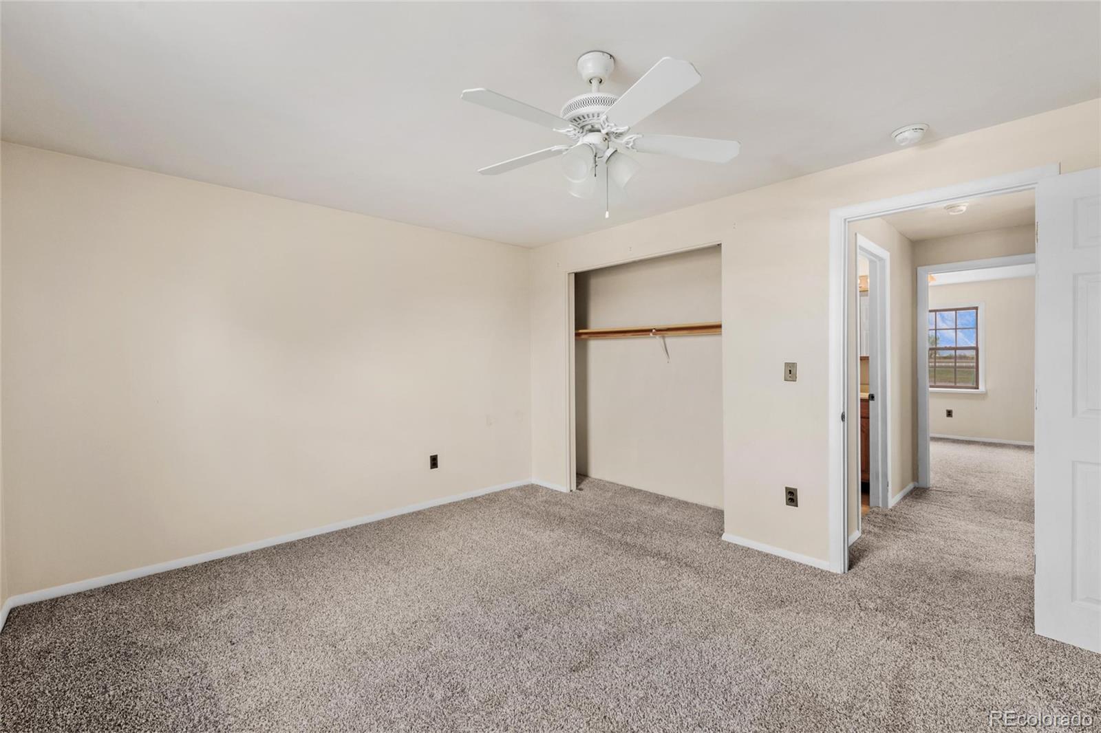 6231 Prospect Road Longmont, CO 80503 - Photo 41 of 45 an empty room with a ceiling fan and a window