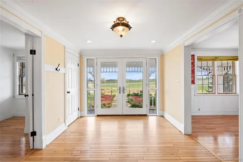 a view of an entryway with wooden floor and a window