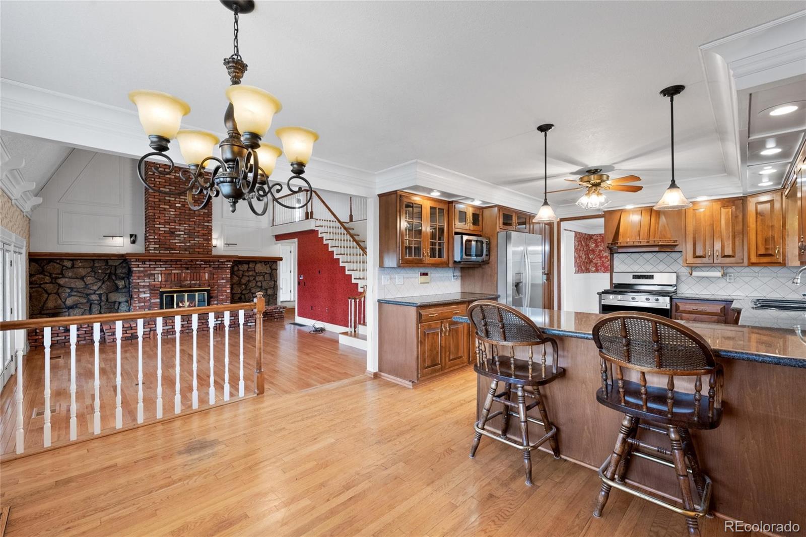 6231 Prospect Road Longmont, CO 80503 - Photo 10 of 45 a view of a kitchen and dining area with chandelier