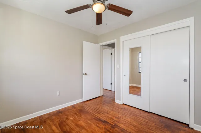 a view of an empty room and wooden floor