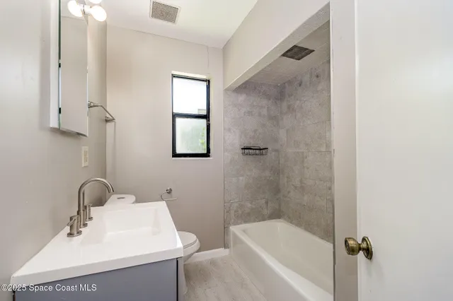 a bathroom with a sink mirror and shower