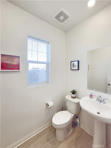 a white toilet sitting next to a bathroom sink