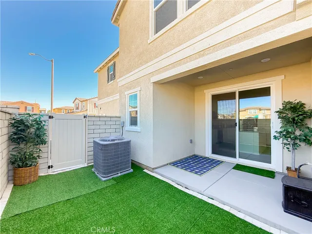 a backyard of a house with table and chairs
