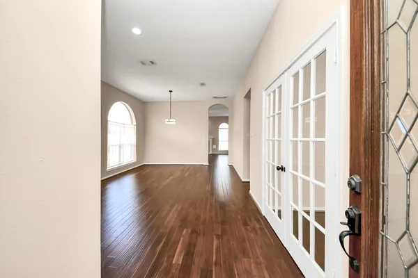 a kitchen with a sink cabinets and wooden floor