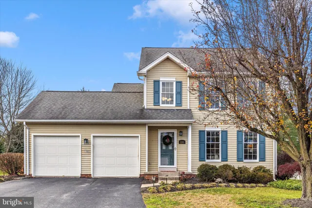 a view of swimming pool with outdoor seating and trees in the background