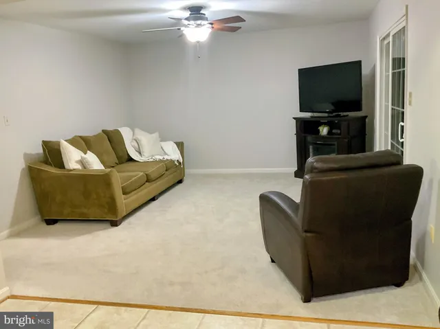 a kitchen with stainless steel appliances kitchen island granite countertop a stove a refrigerator a oven a dining table and chairs with wooden floor