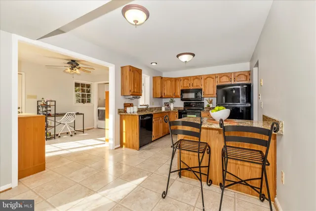 a view of kitchen with cabinets and chairs