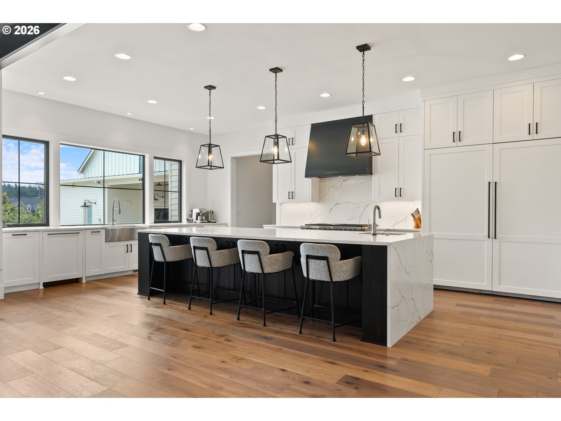 22280 Southwest Stafford Road Tualatin, OR 97062 - Photo 15 of 48 a kitchen with stainless steel appliances kitchen island granite countertop a table chairs sink and cabinets