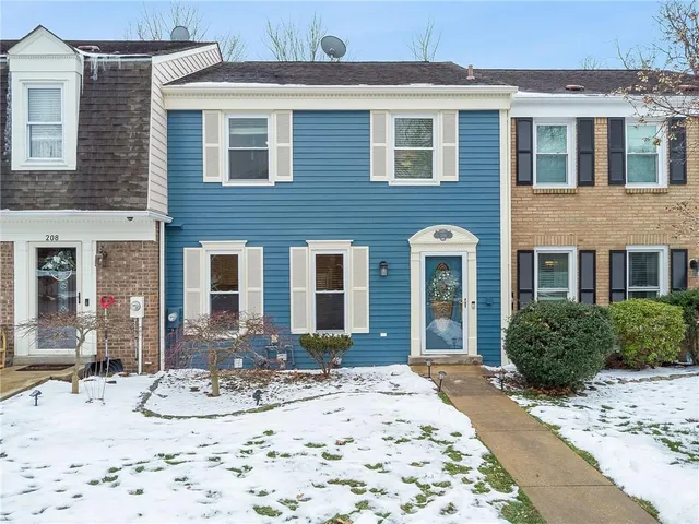 a view of a brick building next to a yard