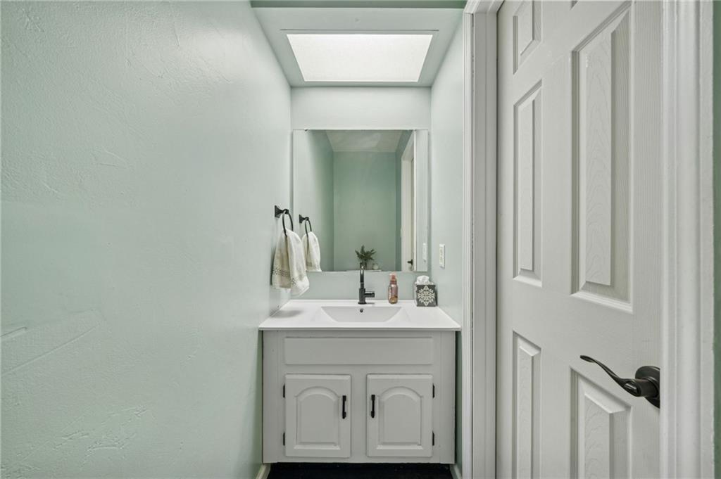 206 Falls Village Road Pittsburgh, PA 15239 - Photo 13 of 38 a bathroom with a sink vanity and a mirror