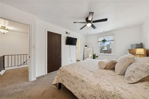 a bedroom with a bed and cabinet