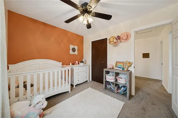 a view of a hallway to a livingroom with furniture