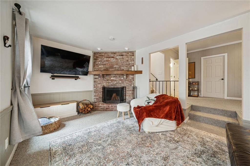 206 Falls Village Road Pittsburgh, PA 15239 - Photo 27 of 38 a living room with furniture a flat screen tv and a fireplace