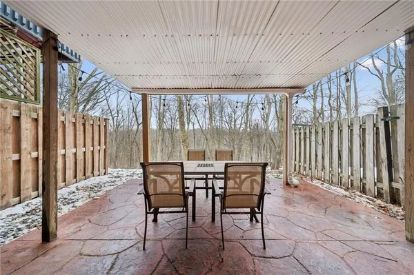 a view of a patio with a table and chairs