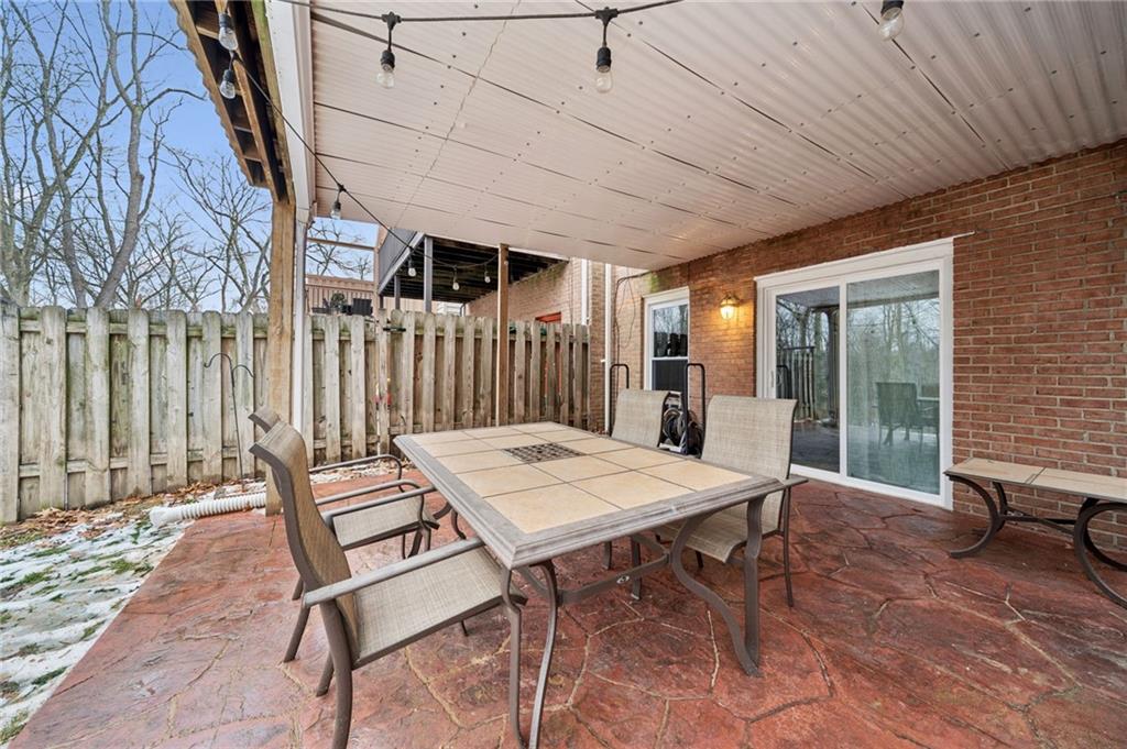 206 Falls Village Road Pittsburgh, PA 15239 - Photo 32 of 38 a view of a patio with a table and chairs