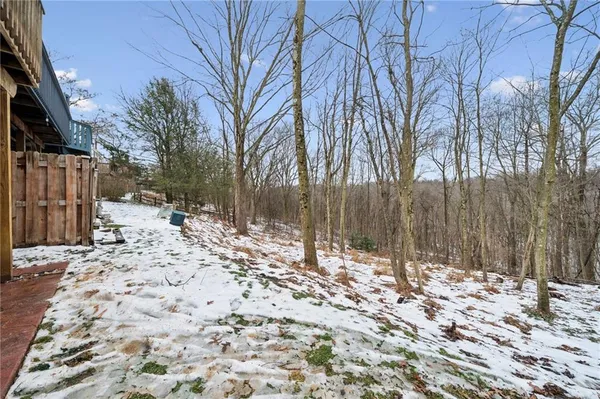 a view of a house with a yard covered in snow