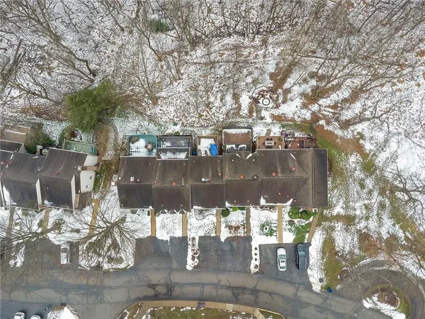 a roof deck with couches and wooden floor
