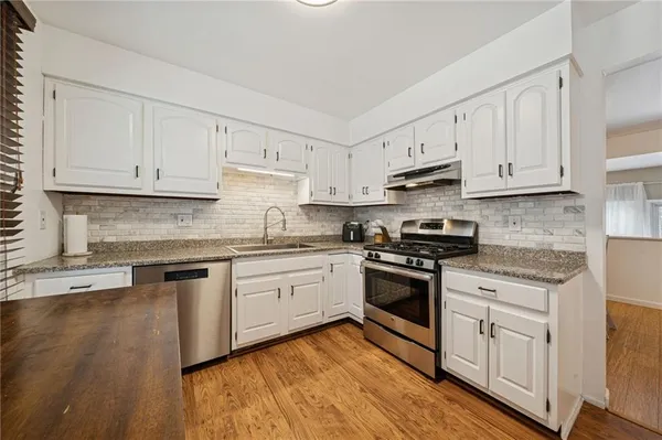 a kitchen with dining table and chairs