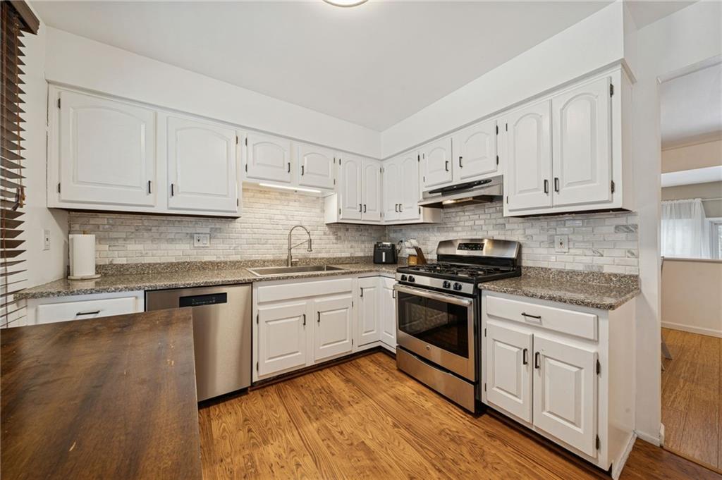 206 Falls Village Road Pittsburgh, PA 15239 - Photo 6 of 38 a kitchen with granite countertop white cabinets and appliances