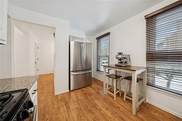 a view of a dining room with furniture and wooden floor