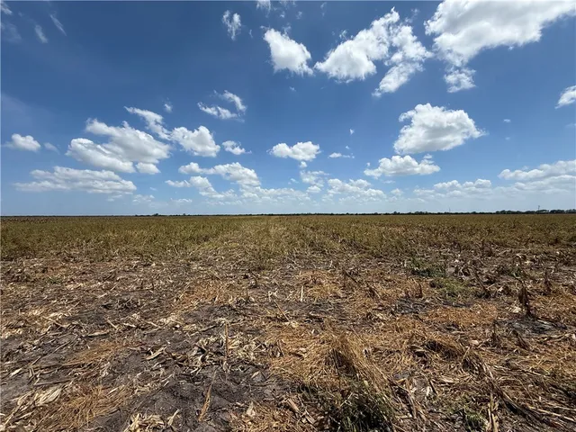 an aerial view of house with yard and mountain view in back