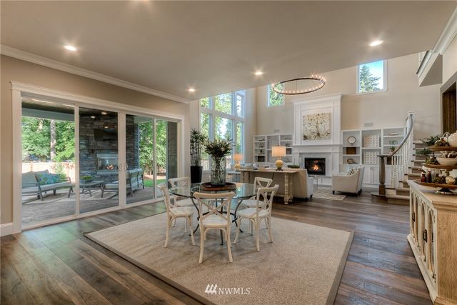 a living room with fireplace furniture and a large window