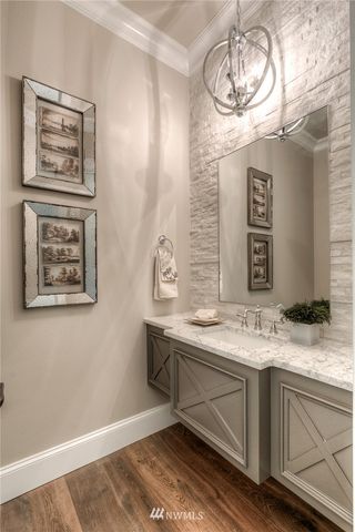 a bathroom with a sink a mirror and a window