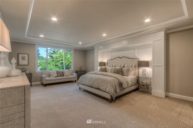 a bedroom with a bed couch and a window