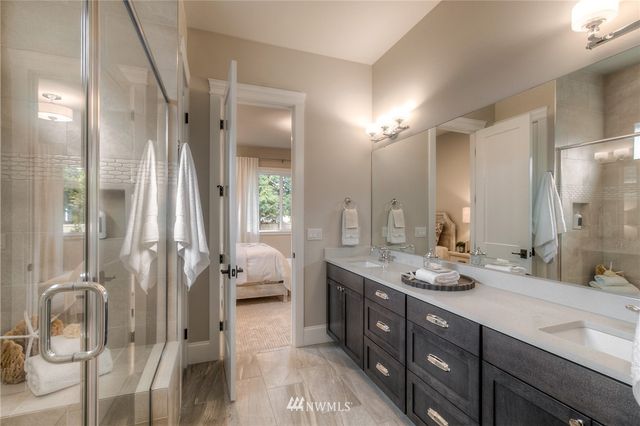 a bathroom with a double vanity sink mirror and double