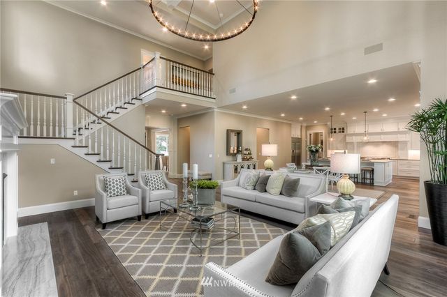 a living room with furniture and a chandelier
