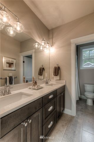 a bathroom with a double vanity sink and a mirror