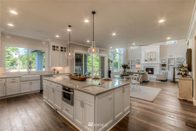 a open kitchen with stainless steel appliances granite countertop a stove and more cabinets