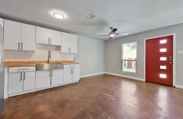 a kitchen with cabinets stainless steel appliances and a counter space