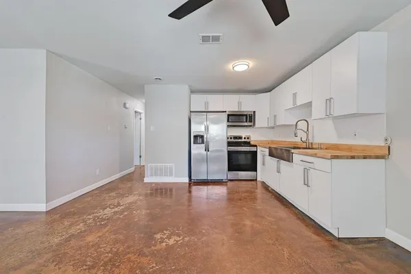 a view of kitchen with refrigerator and window
