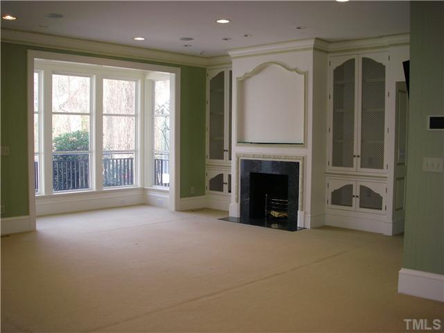 2904 Fairview Road Raleigh, NC 27608 - Photo 10 of 25 a view of a livingroom with an empty space and a fireplace