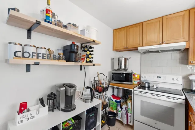 a kitchen with lots of clutter and cabinets