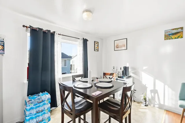 a view of a dining room with furniture and chandelier