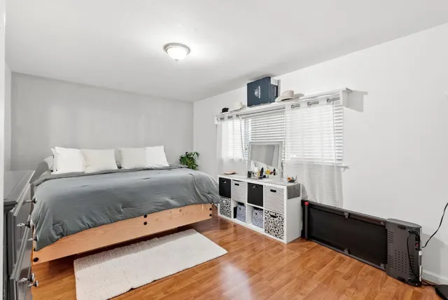 a bedroom with a bed and a potted plant