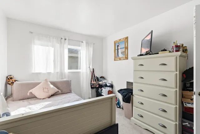 a bed room with a bed and chair