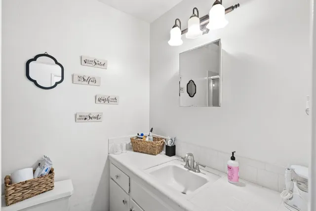 a bathroom with a sink mirror toilet and bathtub