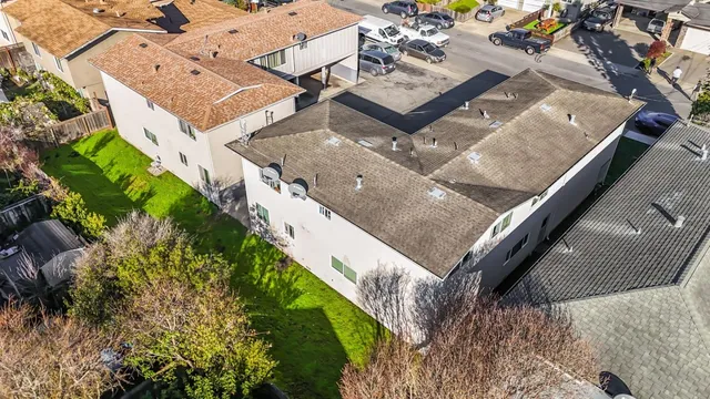 an aerial view of residential houses with outdoor space and swimming pool