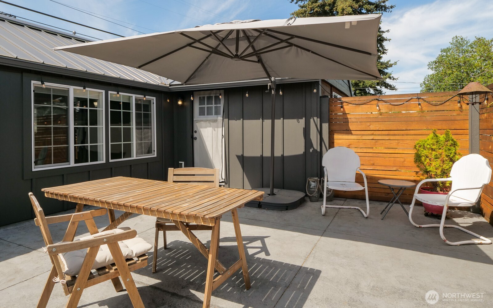 233 West Washington Street Sequim, WA 98382 - Photo 3 of 40 a patio with a table and chairs and potted plants