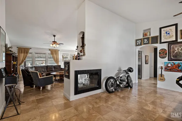 a spacious bedroom with a bed and a chandelier
