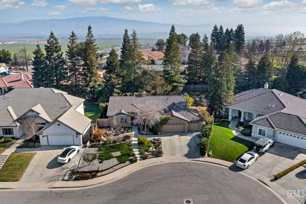 an aerial view of multiple houses with yard